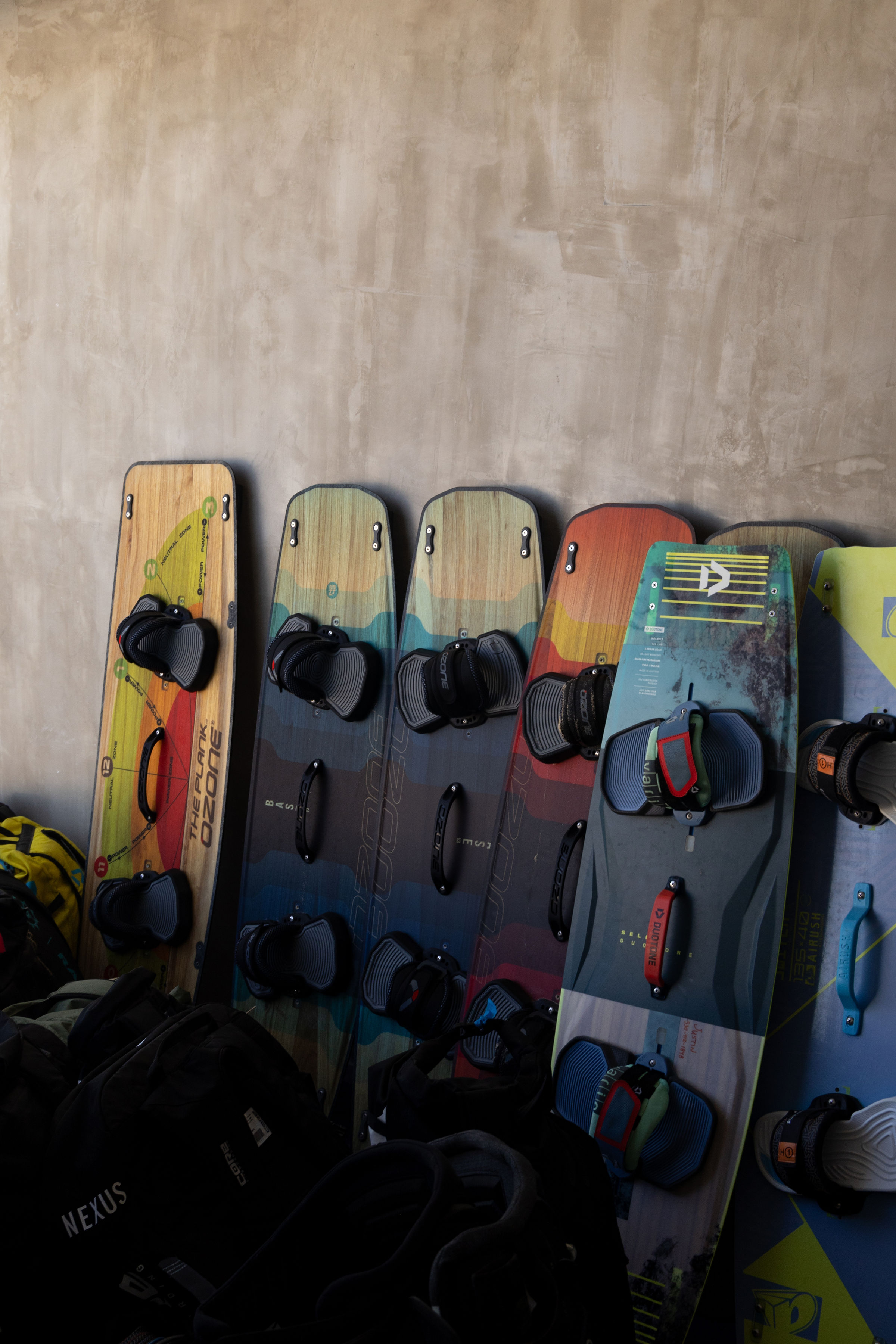 Kiteboarding gear rack with boards and kites ready to rent